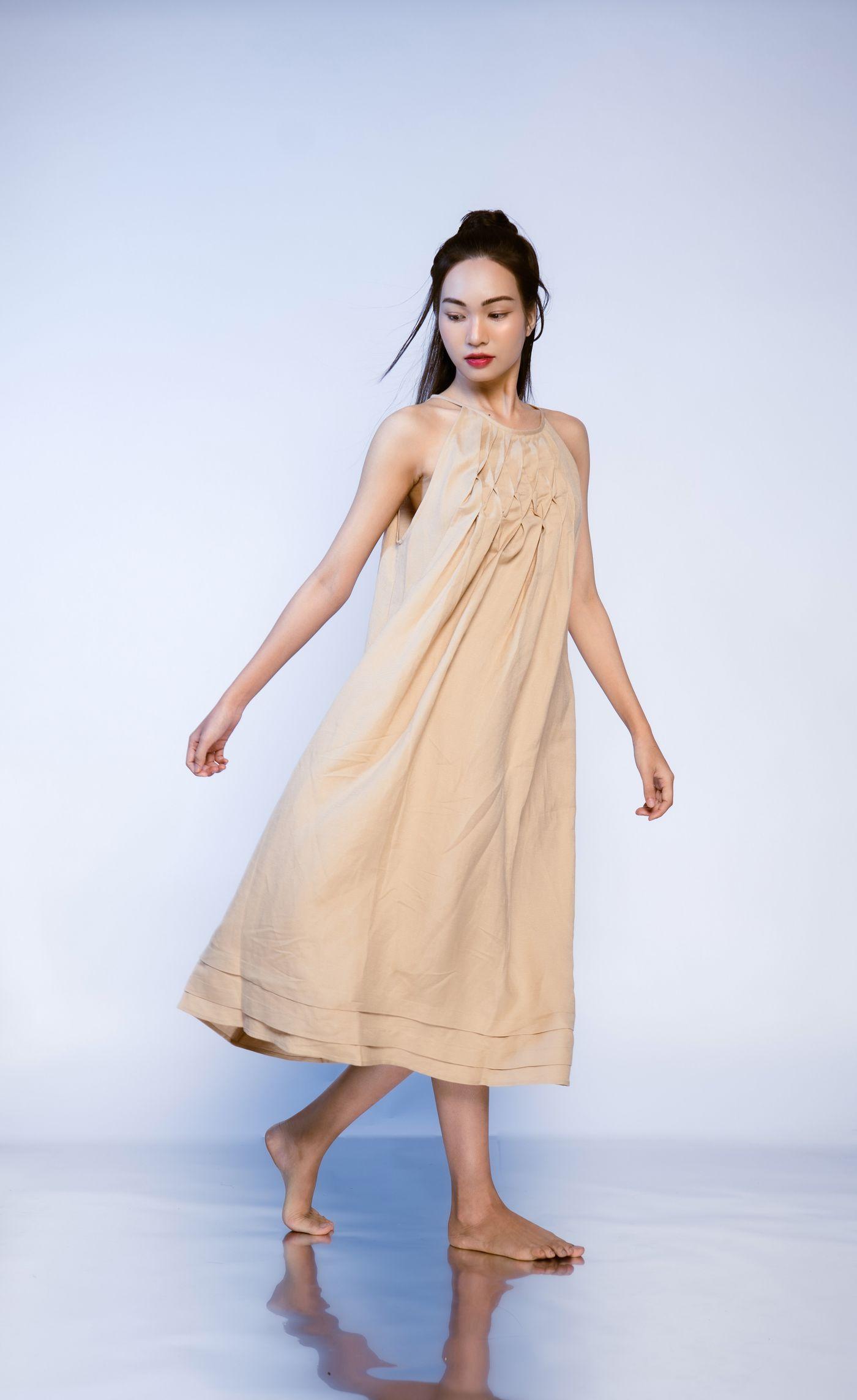 Editorial fashion model in a flowing neutral outfit